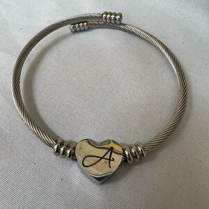 Silvertone coiled bracelet with heart initial A